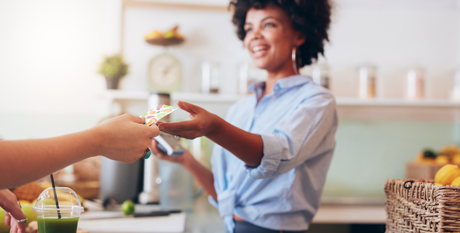 Woman smiles while looking at her smartphone to represent Vynamic Self-Service Enterprise Manager